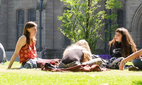 Students on grass across from Whitworth Hall